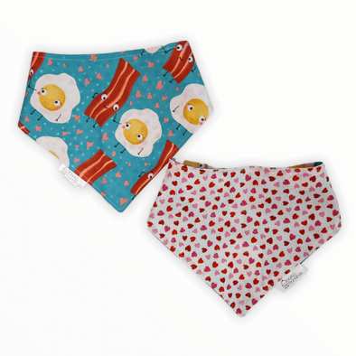 Reversible dog bandana with bacon and eggs holding hands with hearts on one side and small hearts in pink on the other side